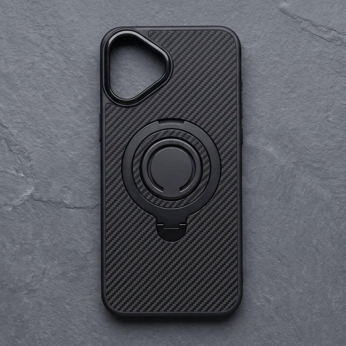 Black carbon fiber MagSafe iPhone case on a grey stone surface